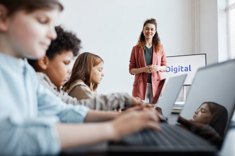 Woman Teaching IT Class in School